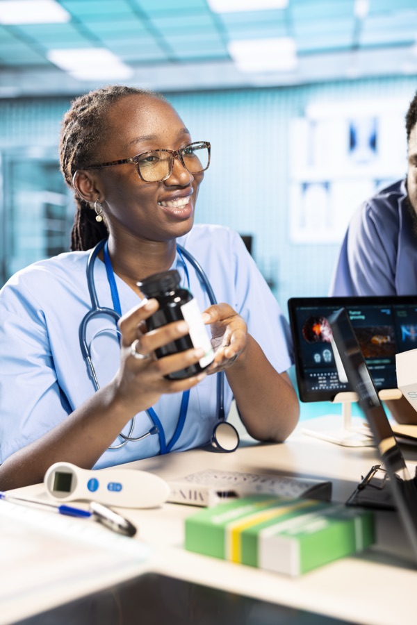 Clinician explaining a bottle of medication to a patient